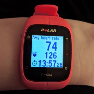 A photo of a Polar M430 watch showing heart rate and session data